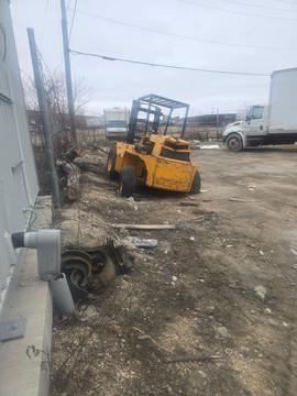 Scrap Metal Recycling Yard with Forklift and Trucks