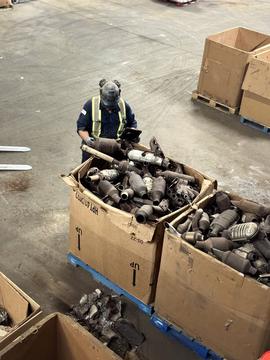 CashForCars USA | Worker Sorting Catalytic Converters in Scrap Yard